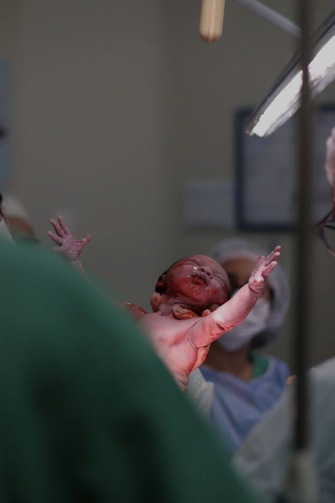a baby is being held up by a doctor