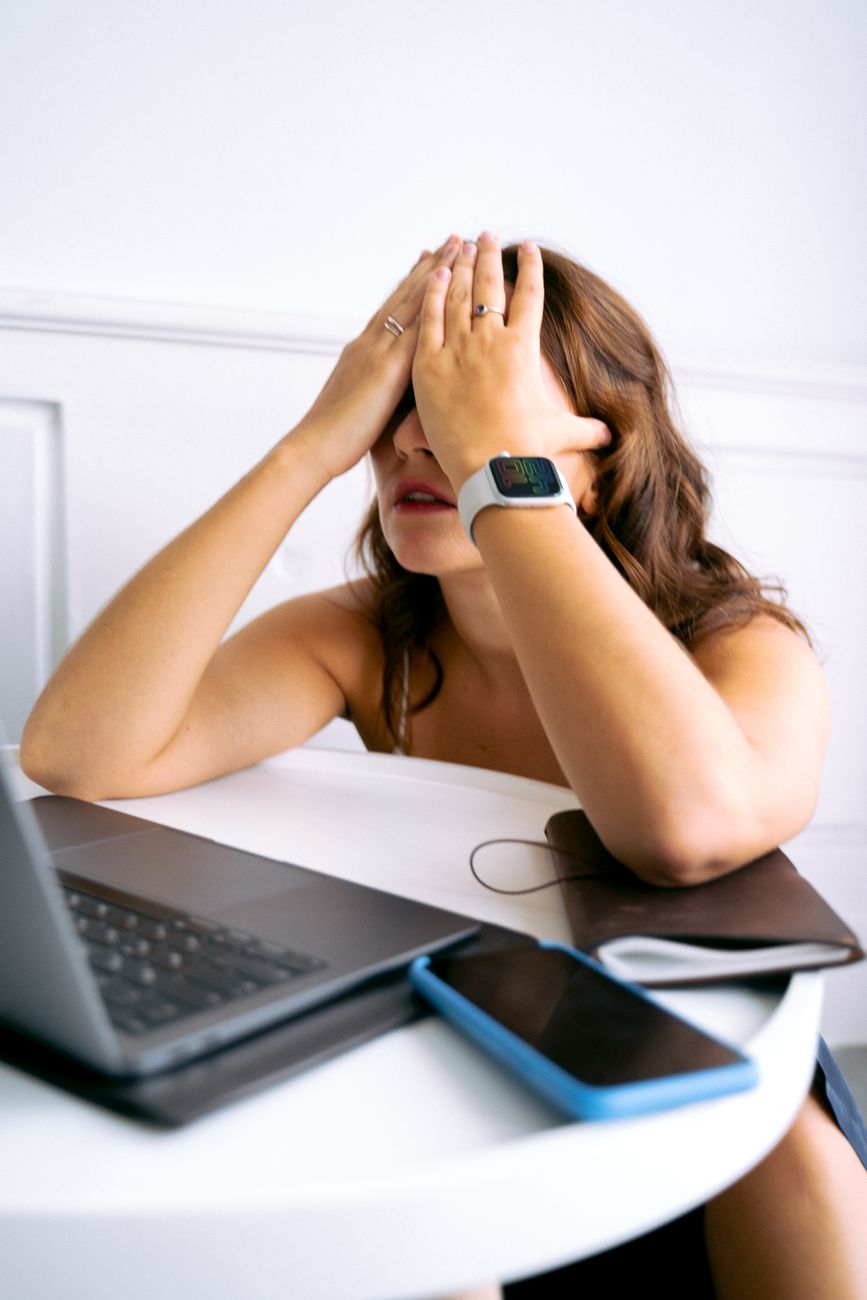 a woman covering her face